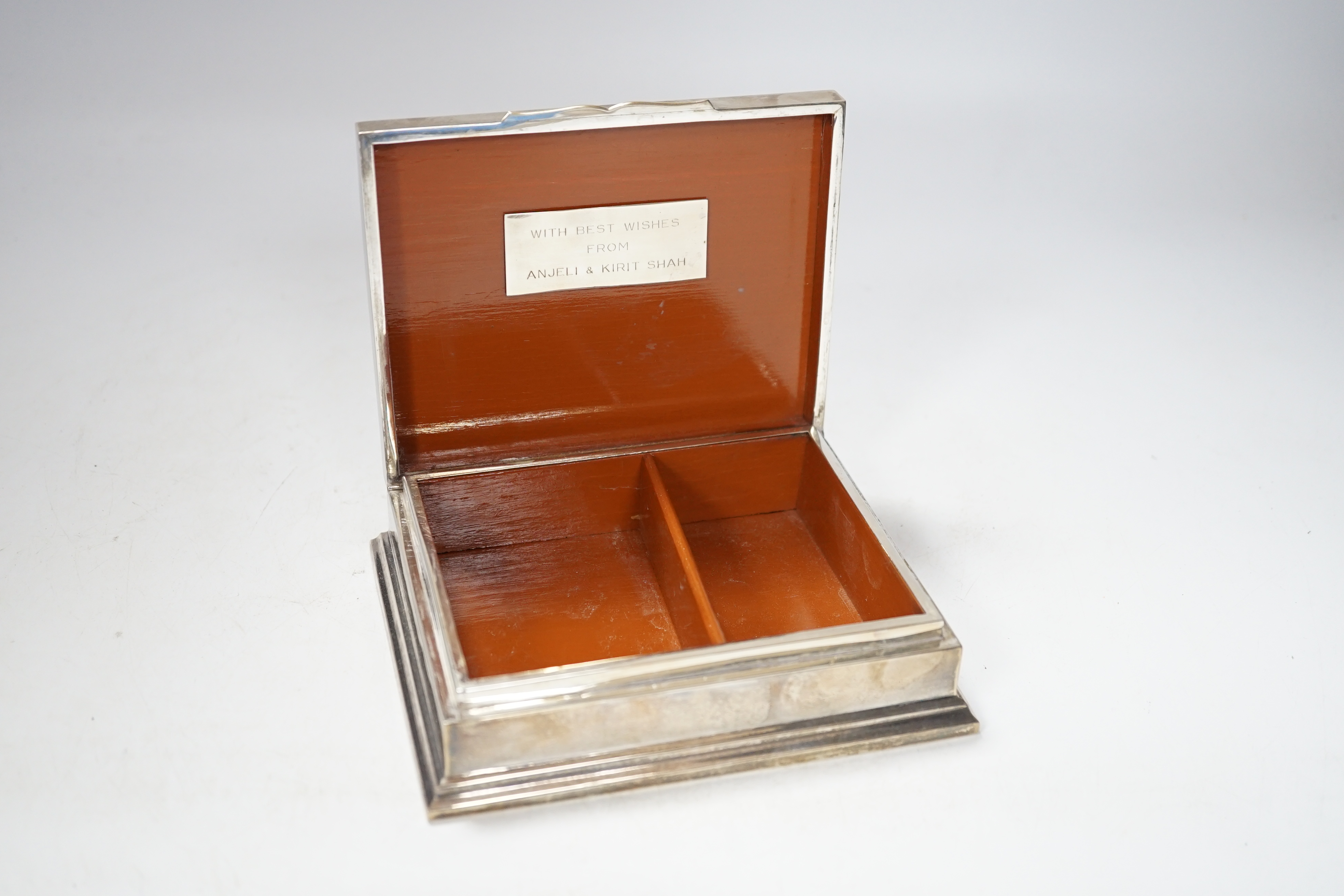 A Thai white metal cigarette box, stamped sterling, 14cm, and a similar sterling overlaid photograph frame, width 16cm